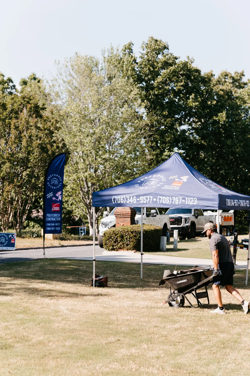 Preferred Roofing & Exteriors branded jobsite tent on a residential roofing project in the Southeast