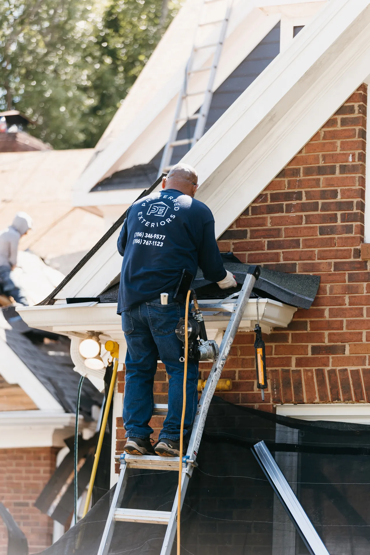 Certified siding installation contractor team working on an Atlanta, GA home exterior