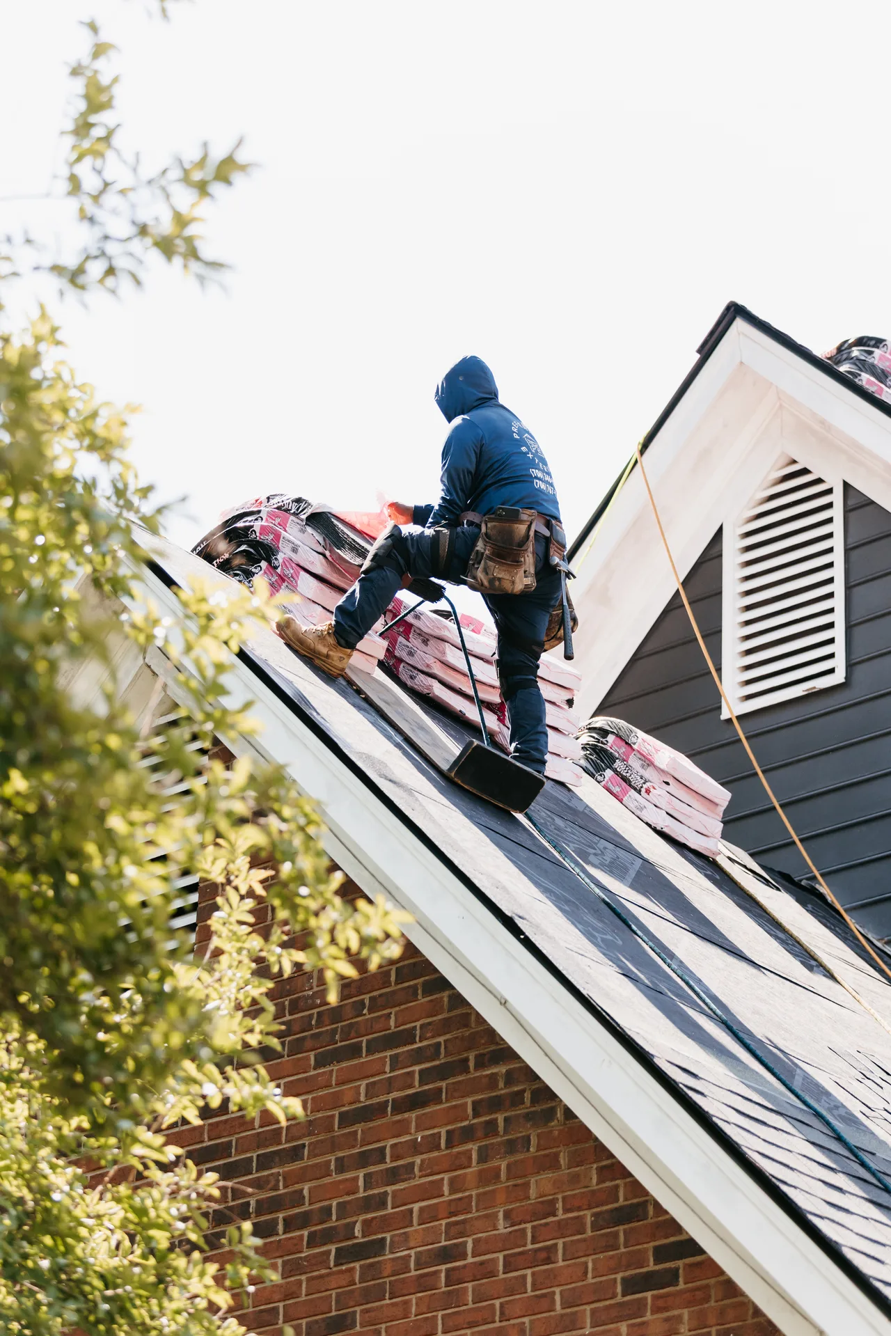 Certified Atlanta roofing contractors installing a new roof on a residential home with proper underlayment and flashing